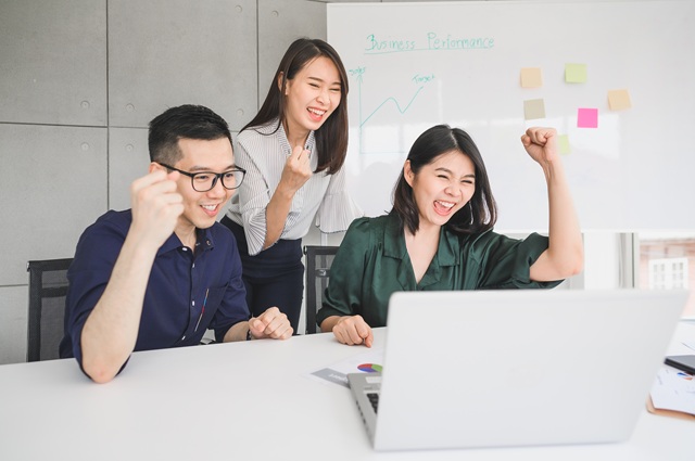Happy young Asian business people celebrated success