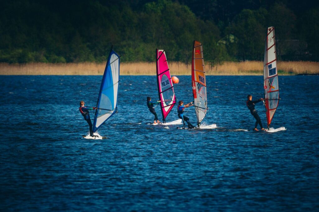 Action-packed windsurfing race featuring colorful sails under a clear sky.