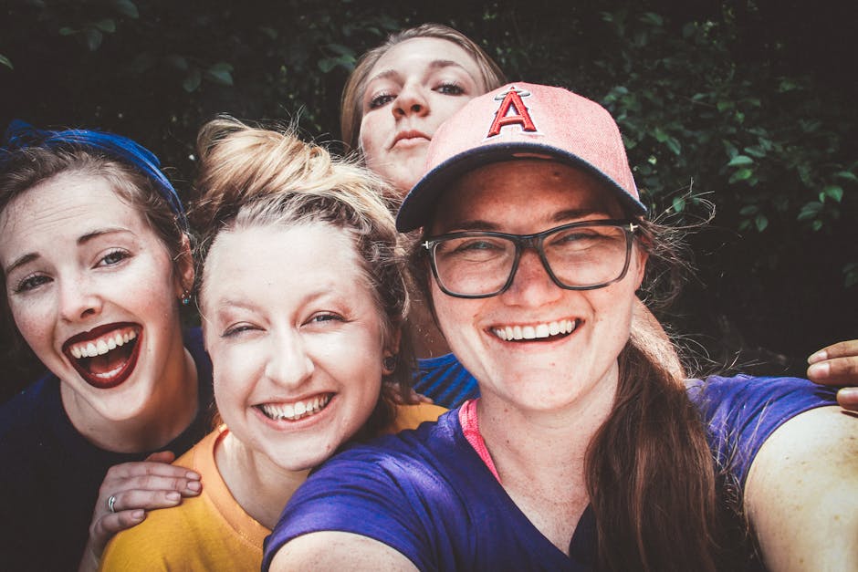 A joyful group of women taking a selfie outdoors, showcasing happiness and friendship.
