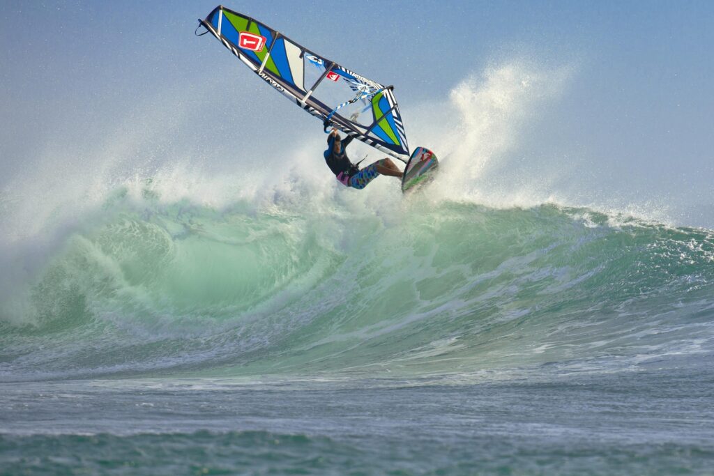 Planche à voile, vague puissante, saut, éclaboussures, sensations fortes.